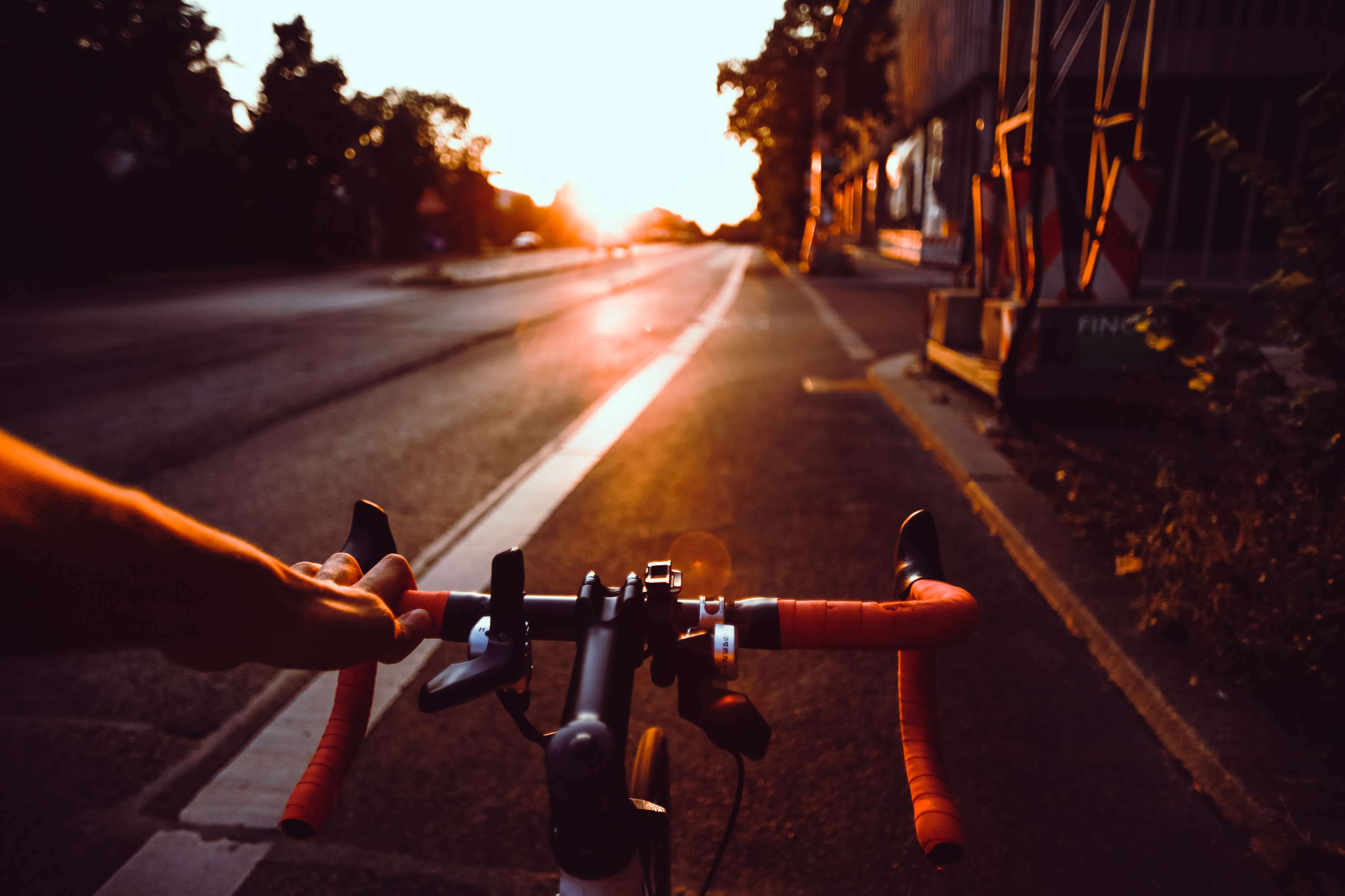 Orange Speed bike on a clean asphalt. Through the field of view of the cyclite